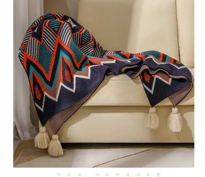 Acrylic sofa blanket with tassel fringe in geometric pattern, showing 130 cm width measurement
