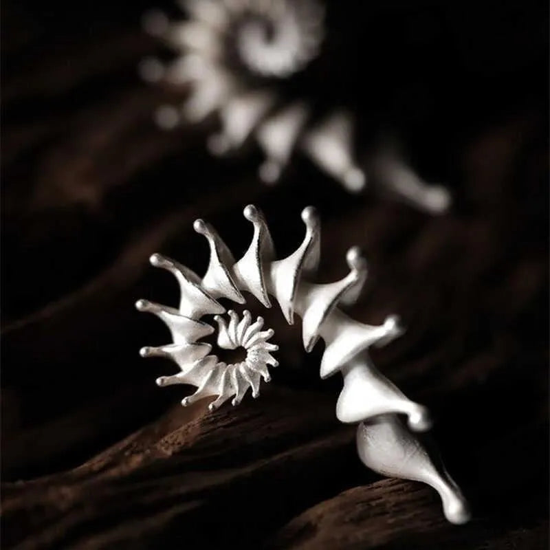 Three-dimensional matte conch stud earrings with irregular geometric shapes