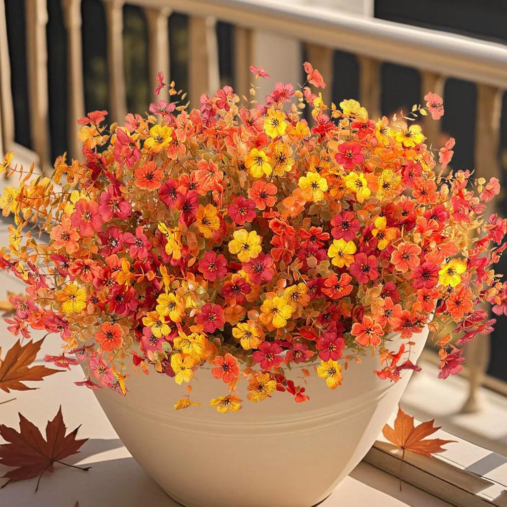 Artificial flower bouquet in autumn red, yellow, orange and orange-yellow colours for home and wedding decoration
