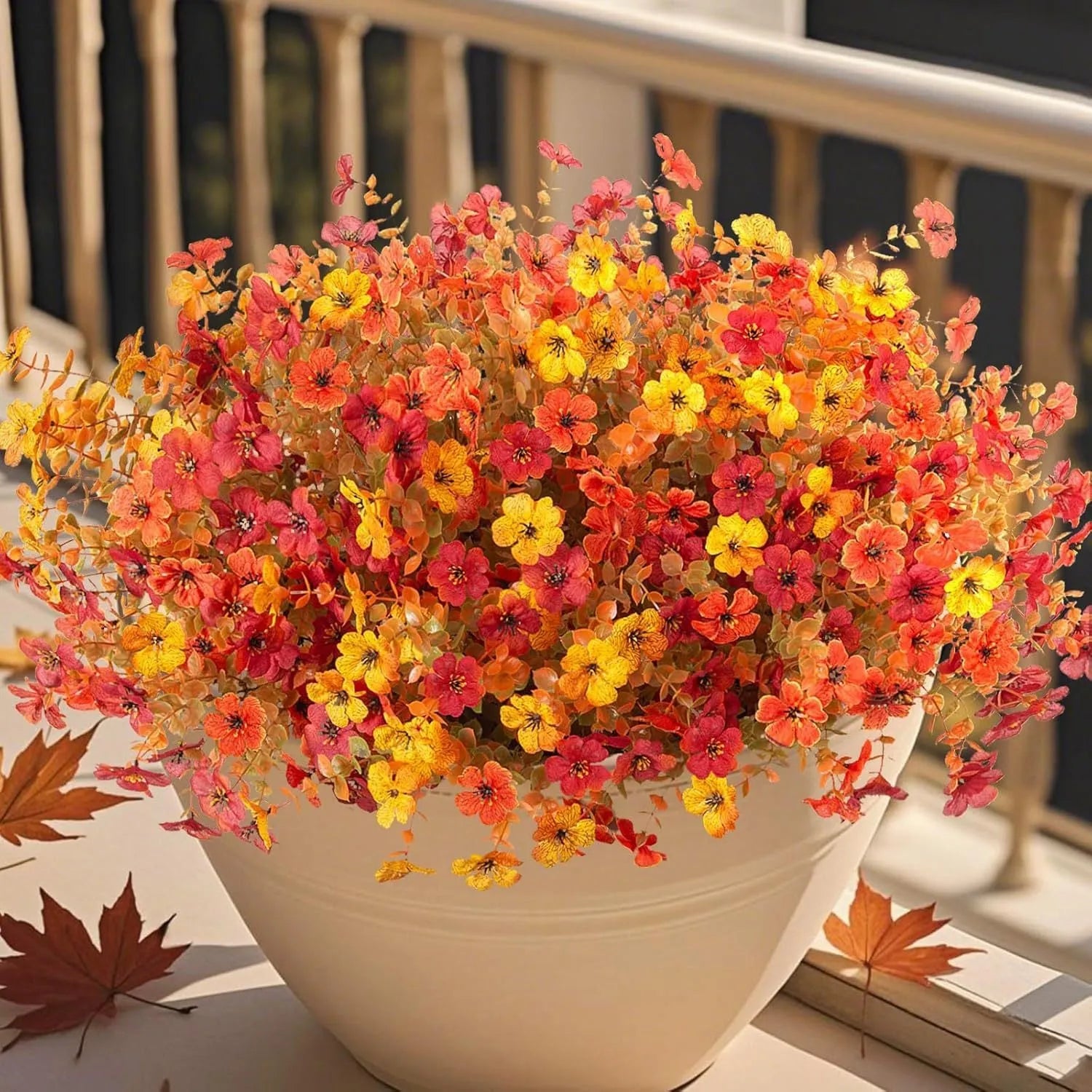 Artificial flower bouquet in autumn red, yellow, orange and orange-yellow colours for home and wedding decoration