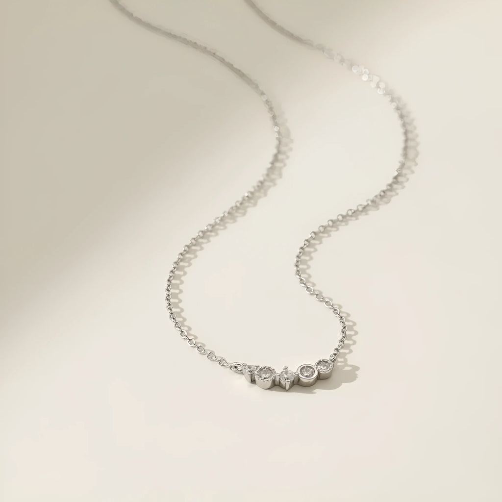 Geometric zircon pendant necklace in 925 silver with gold electroplate finish on display