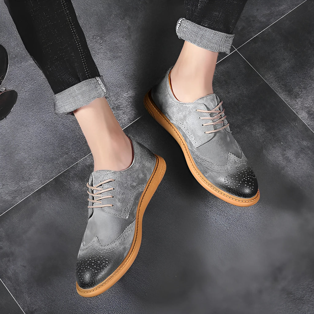 Men's black leather low-top lace-up business shoes with a rubber sole on a plain background.