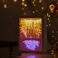 Modern romantic night light with three-dimensional paper carving design and remote control on a bedside table.