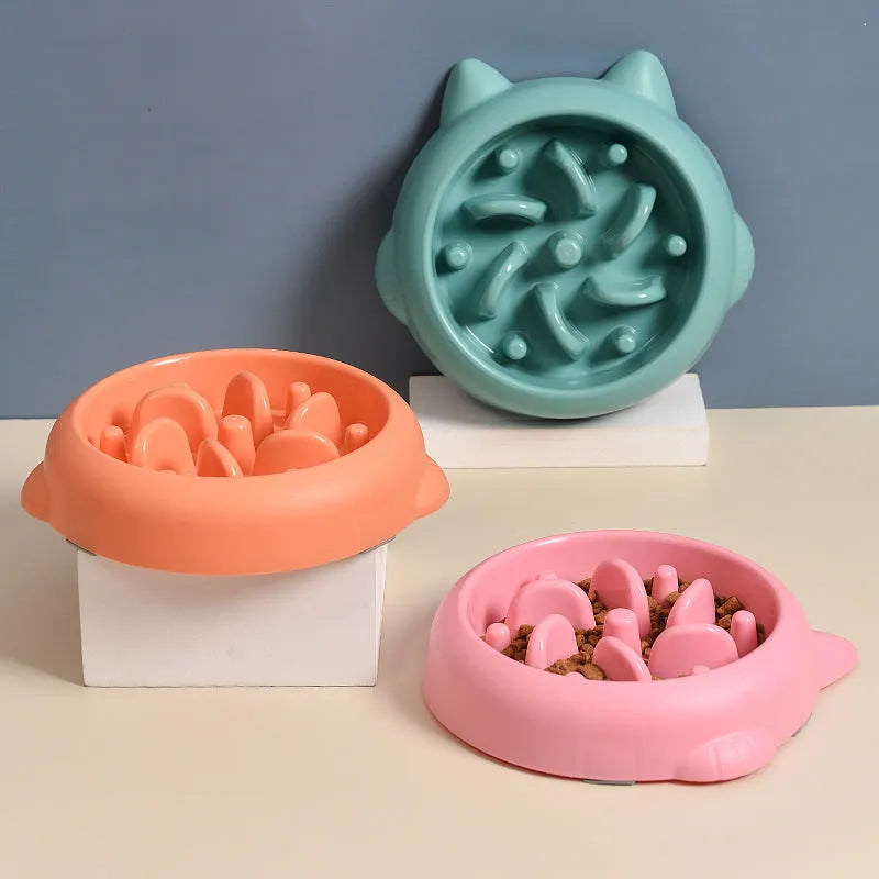 Green pet slow feeder bowl with raised bone-shaped obstacles inside to slow down eating.