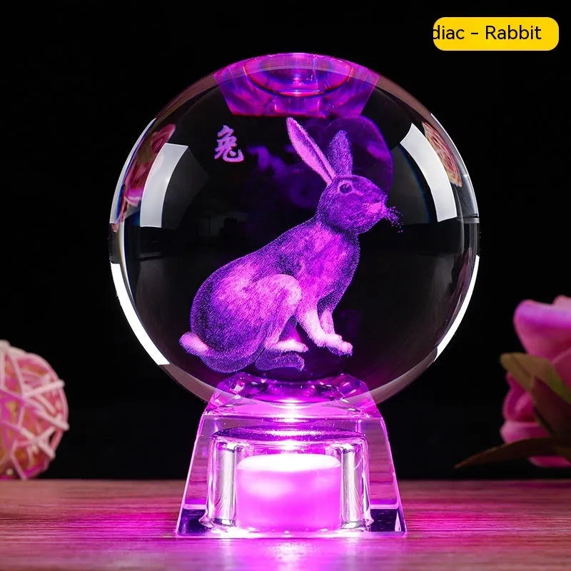 White crystal zodiac decorative ball with electronic base lighting showing Chinese-style animal design