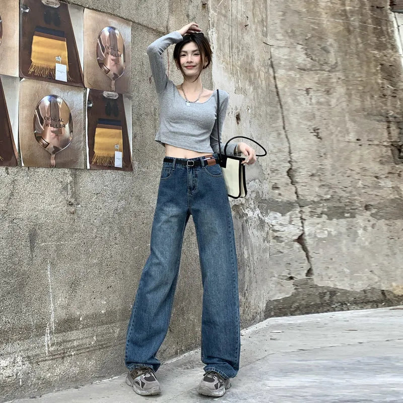 A pair of women's retro blue high-waisted straight-leg jeans laid flat, showcasing the classic five-pocket design.