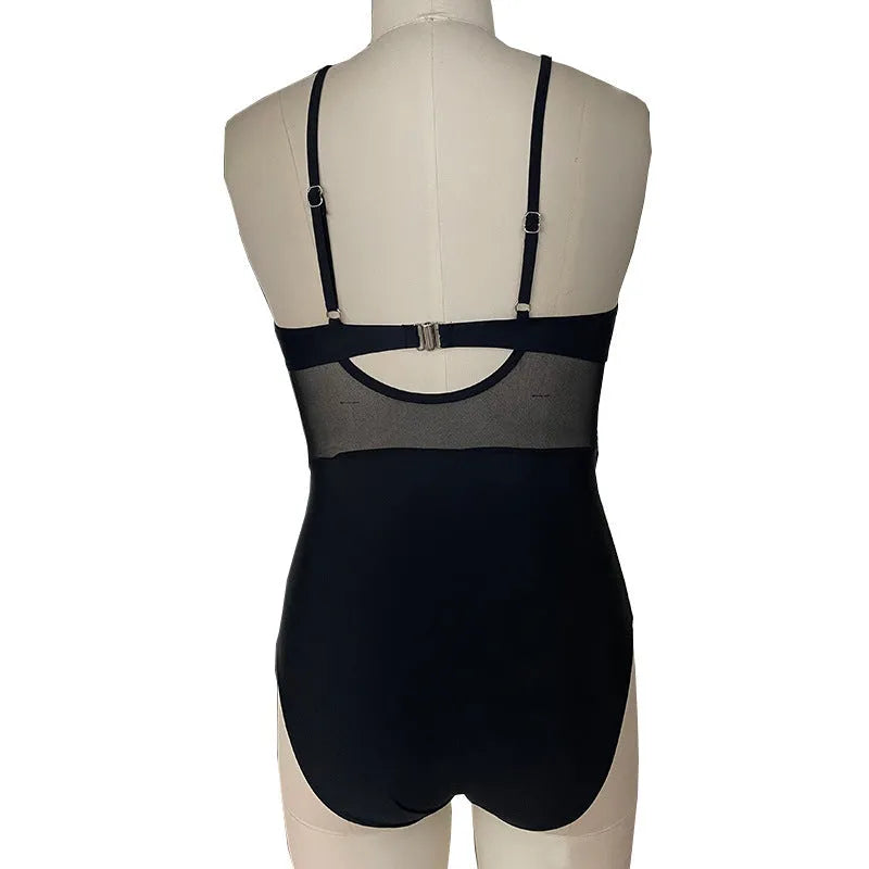 Women's black mesh spliced backless one-piece swimsuit on model