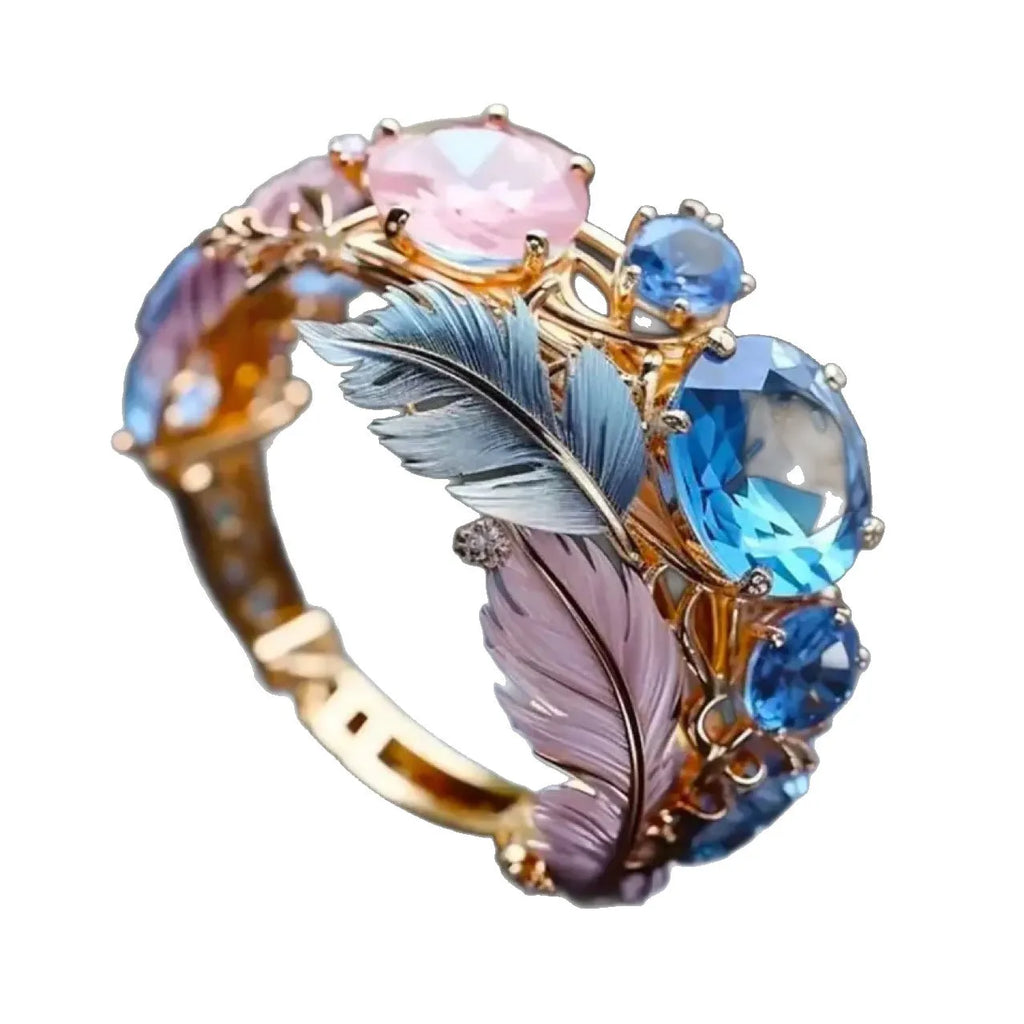 Brass feather ring with embossed design and zircon stones in geometric gold colour