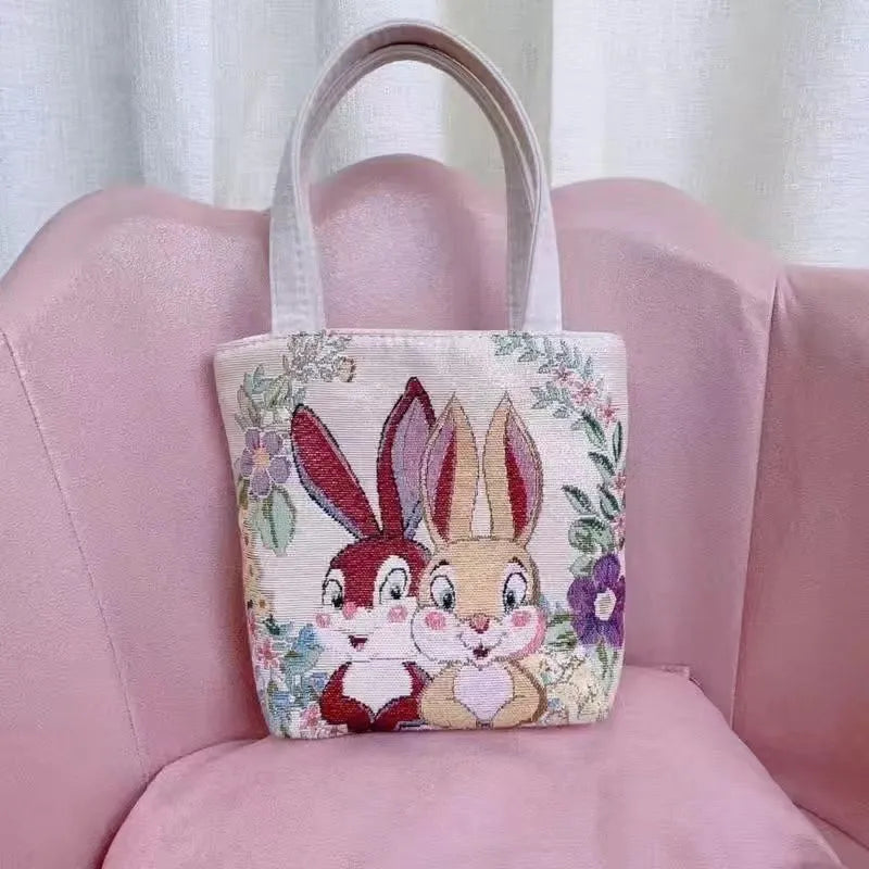 Double-sided gold wire embroidered canvas tote bag showing Bunny design with reinforced base