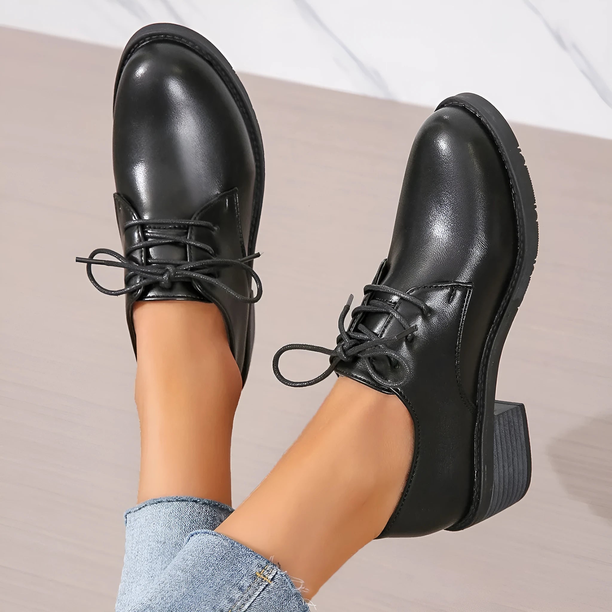 Black women's low-top work shoes with a chunky heel, PU leather upper, and rubber sole.