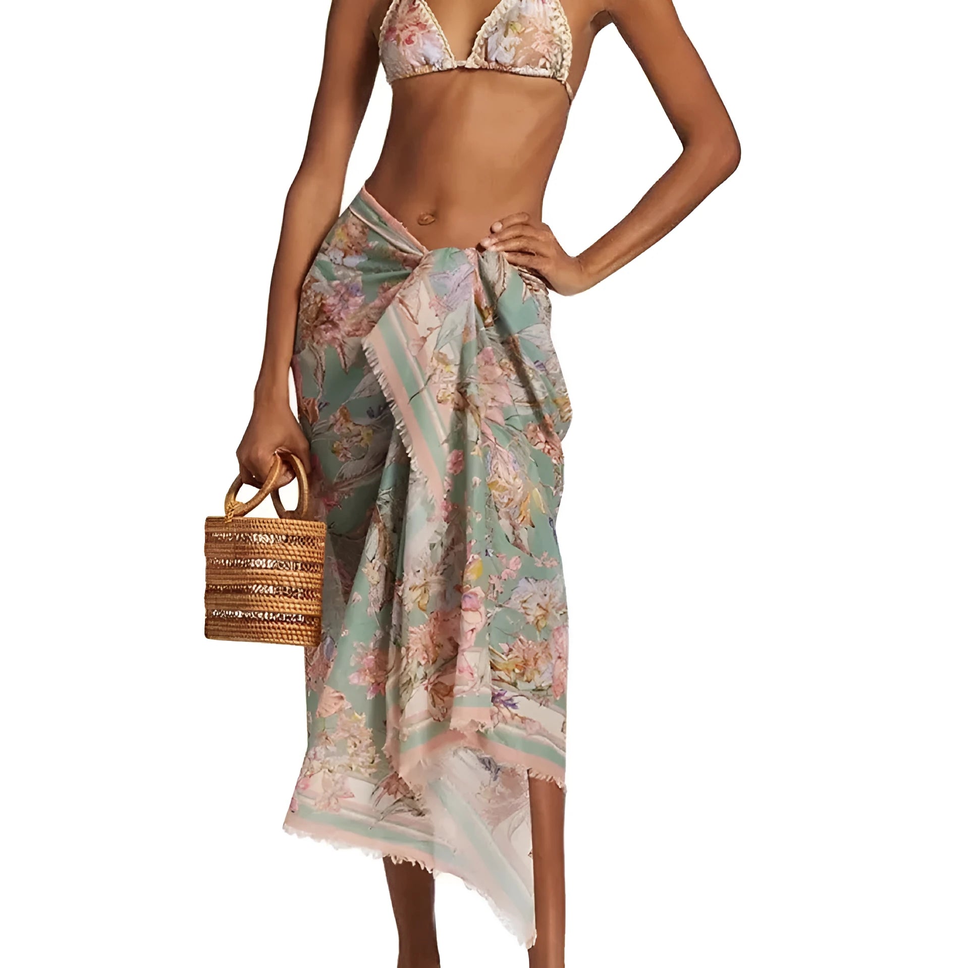 Creamy-white floral women's bikini set with matching skirt on beach