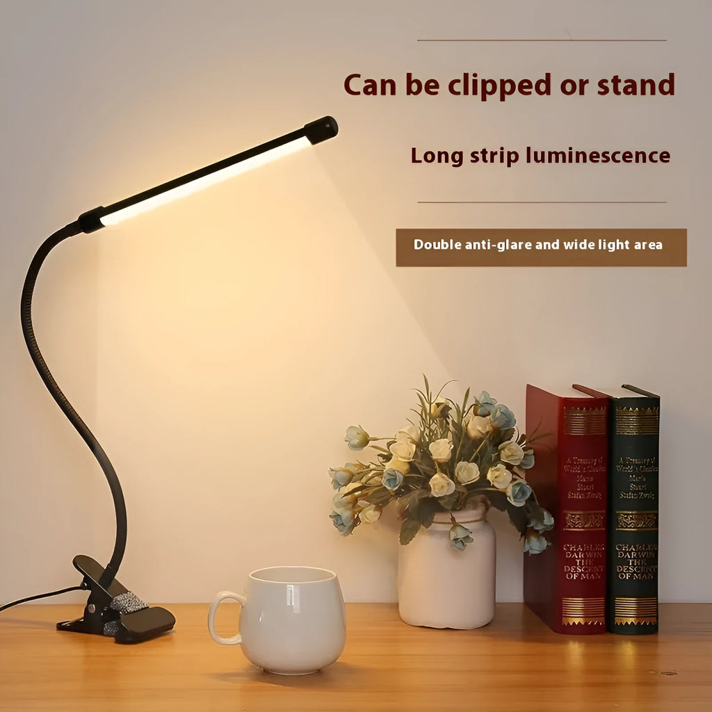 Black and white 26cm USB-powered LED desk lamp on a desk for study lighting.