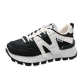 A pair of solid-colour low-top lace-up sneakers with a round toe and flat rubber sole.