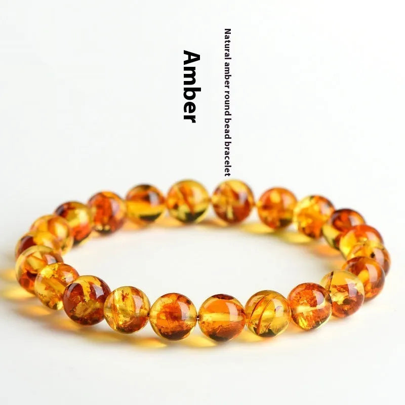 Yellow piebald amber bracelet with geometric beads showing natural flower spot patterning