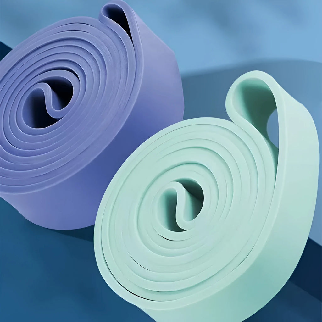Set of five TPR stretch resistance bands in light blue, grey, pink, fruit green, and dark blue on a white background