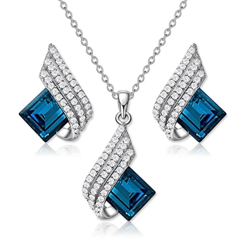 Glass pendant on an alloy cross chain necklace with matching ear studs, in two colour style options.