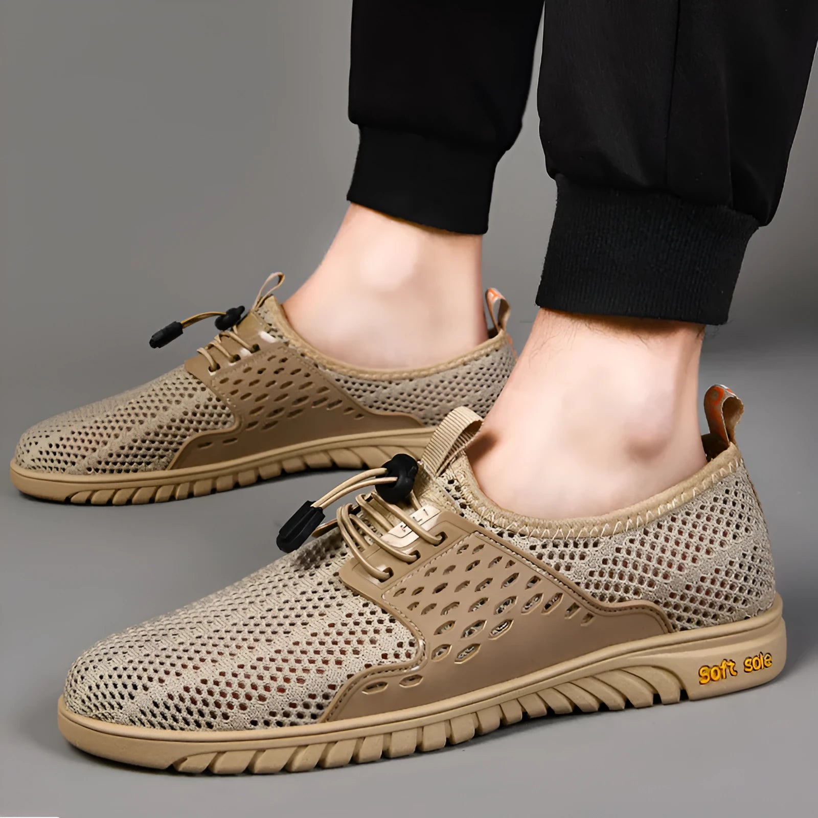 Men's black mesh casual sports shoes with elastic band and rubber sole.
