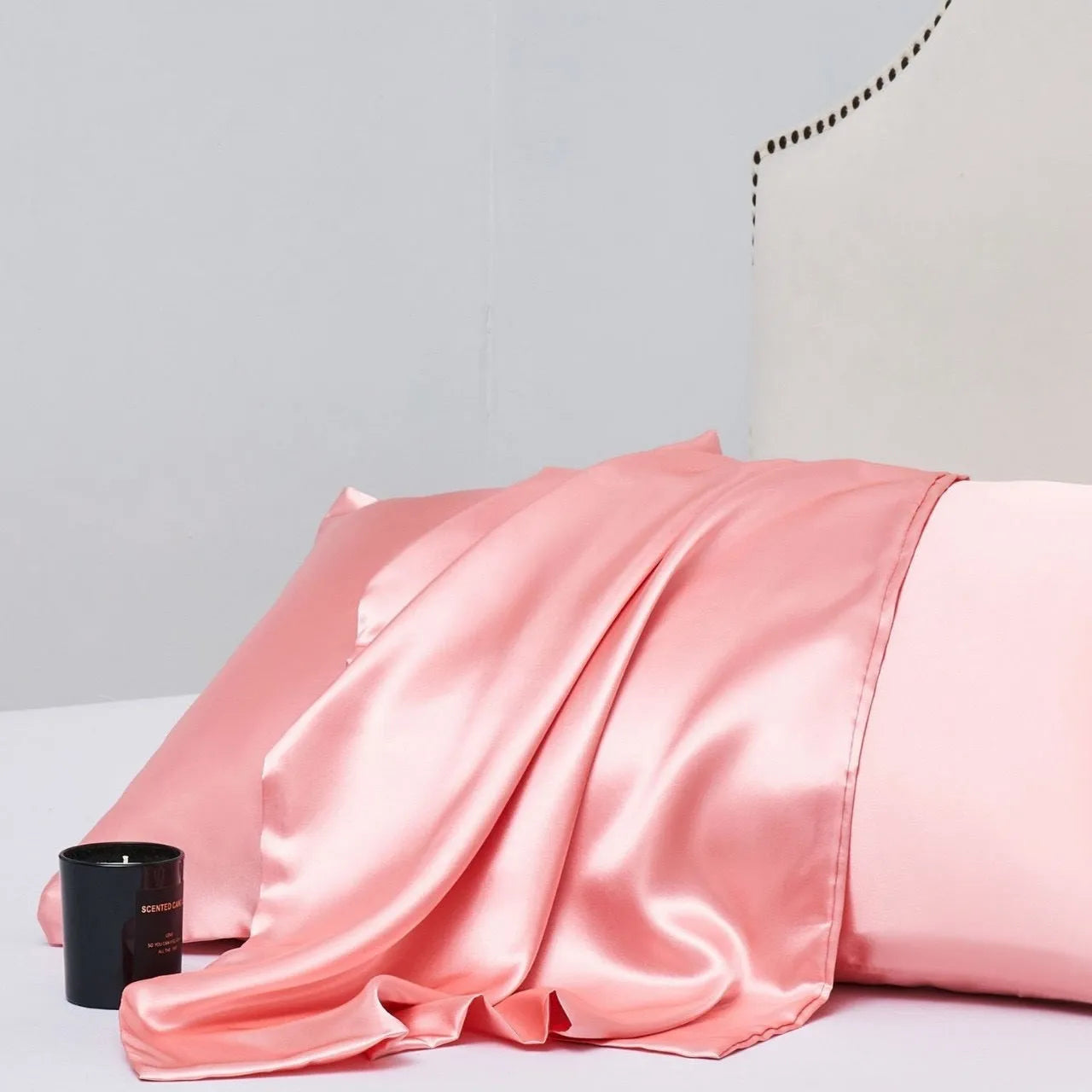 Pair of solid colour satin cloth pillowcases showing colour options including navy blue, wine red and light pink