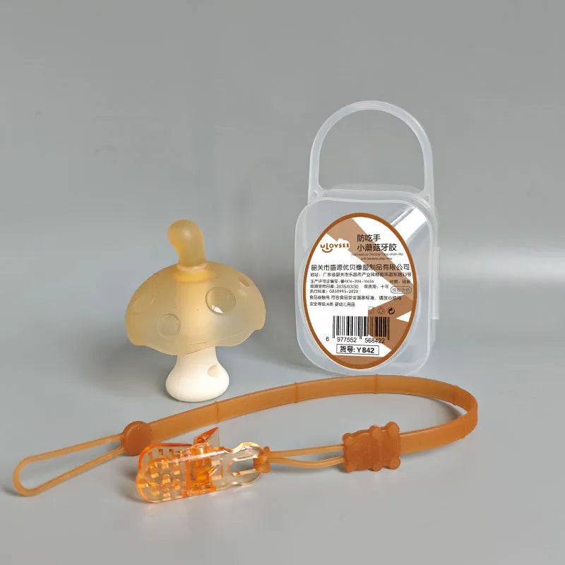 Small mushroom-shaped silicone chewing gum on a chain, in pink or nano colour, inside a transparent box.