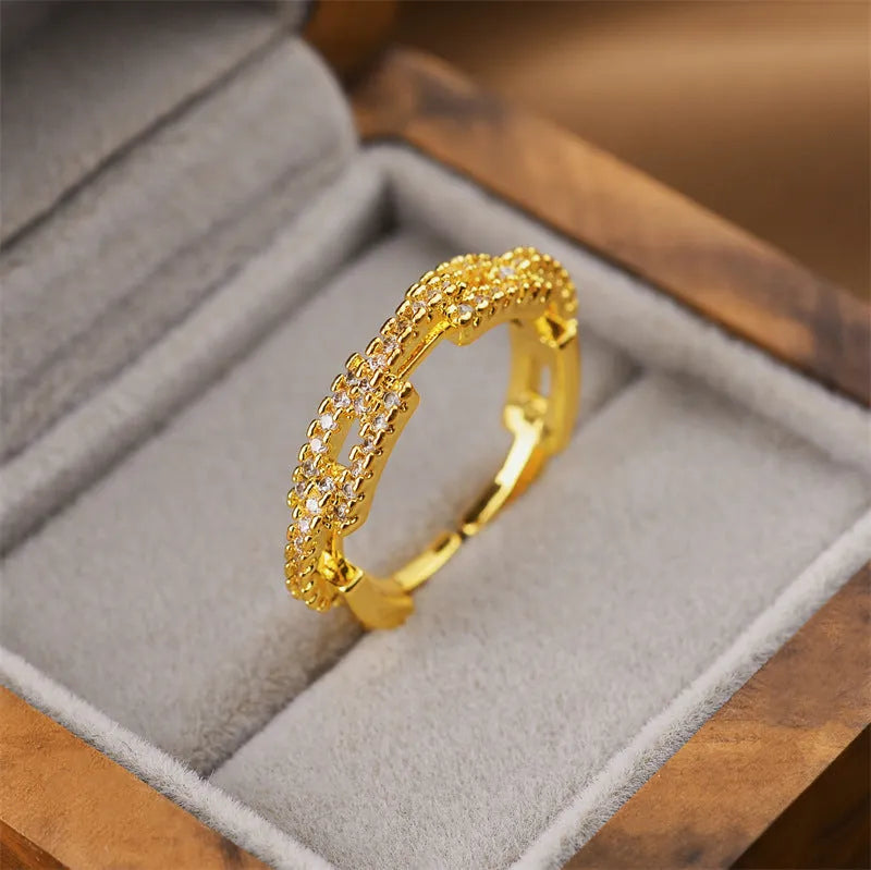 Gold tone geometric open back fashion ring on a hand, showing its adjustable design.