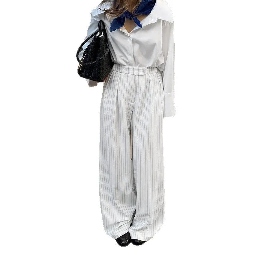 White striped wide-leg casual trousers with a zip closure on a hanger.