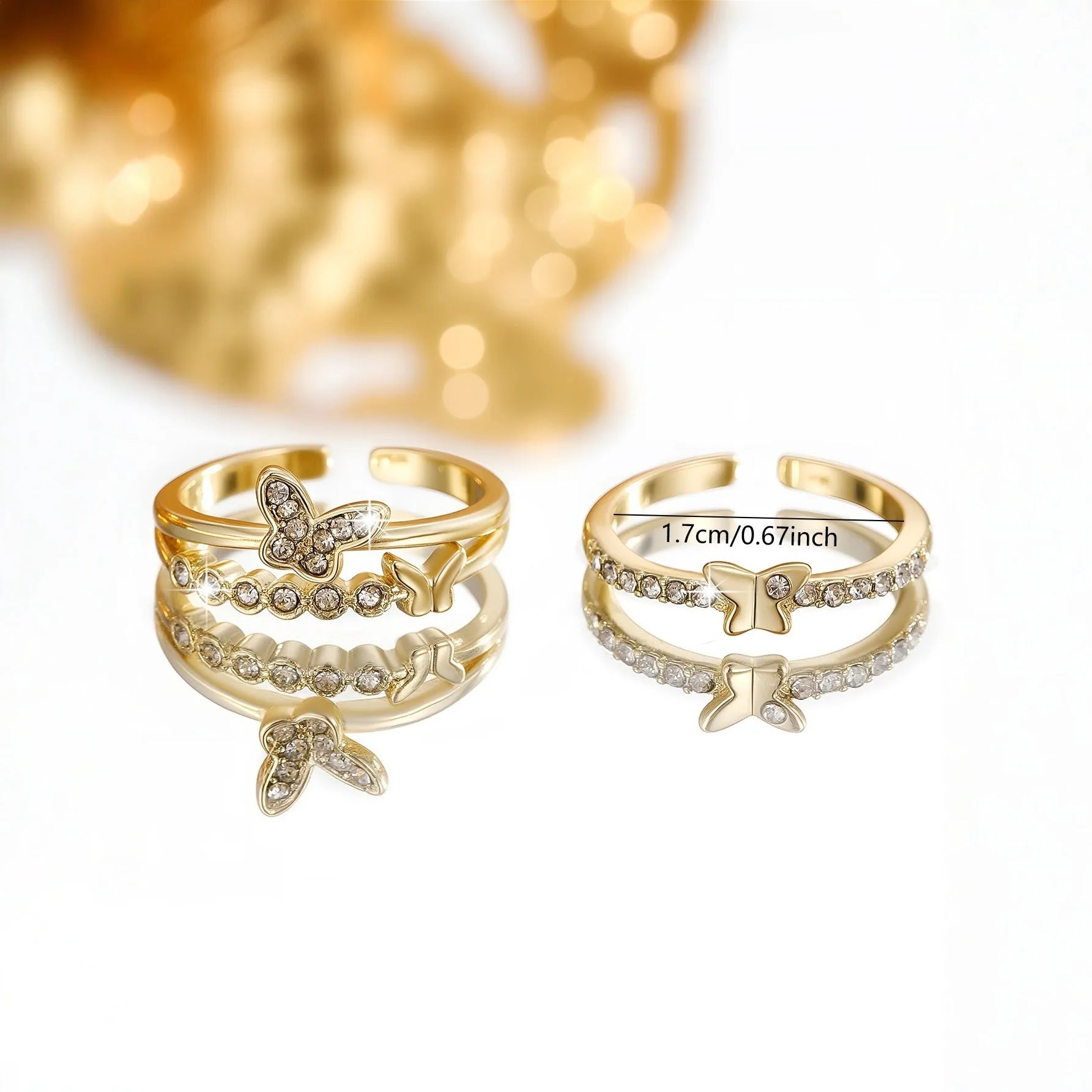 Gold adjustable butterfly ring on finger against white background