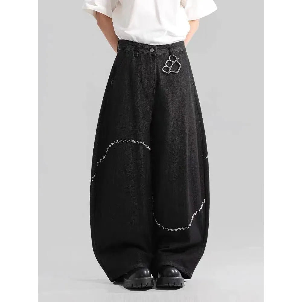 Black straight-leg denim trousers with a mid-waist and zip fly, laid flat.