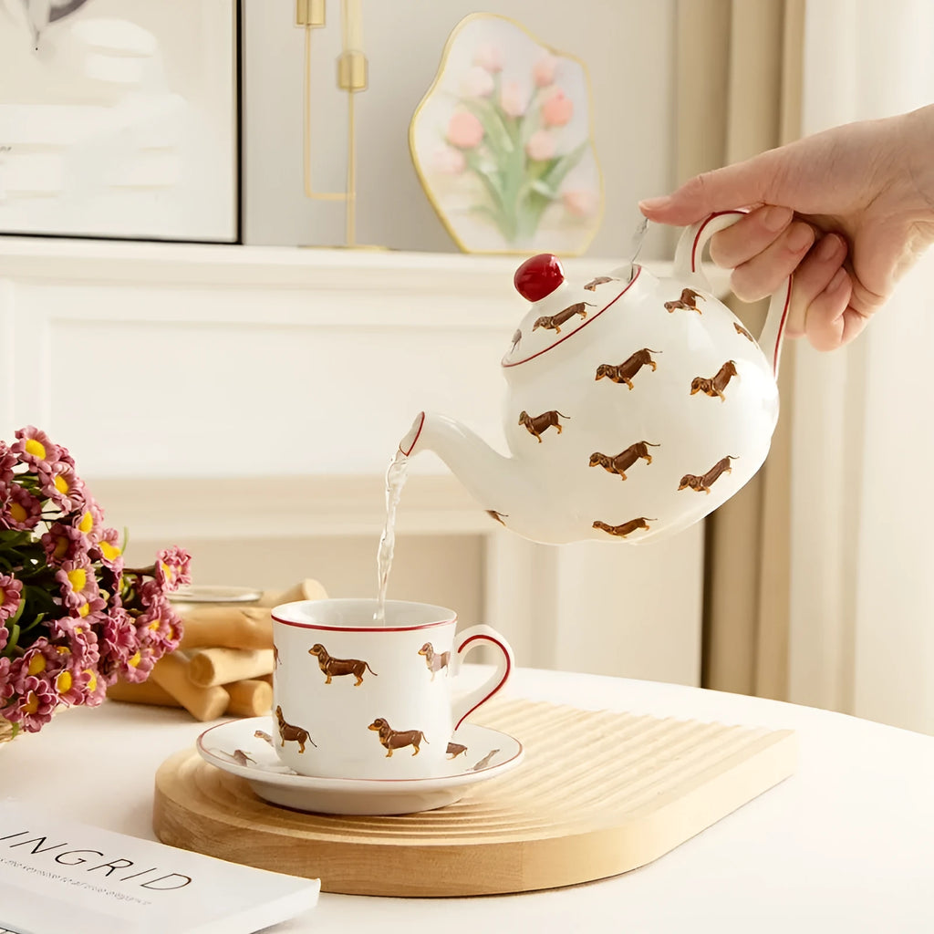 Ceramic sausage dog teapot mug cup and saucer three-piece set on table