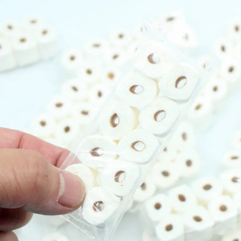 Small white simulated toilet paper roll model for children's educational toy play.