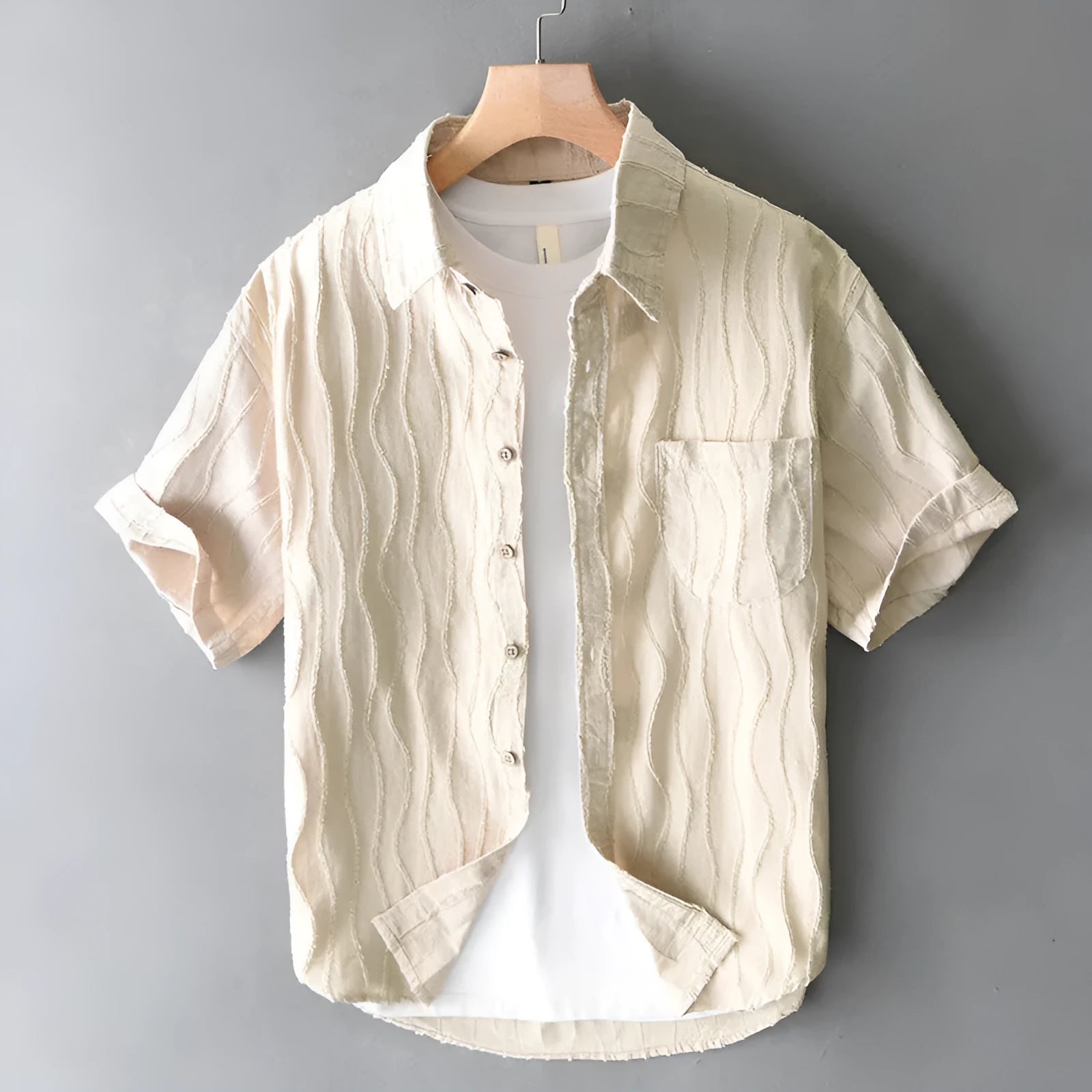 Man wearing a loose fit apricot coloured pure cotton short sleeve casual shirt