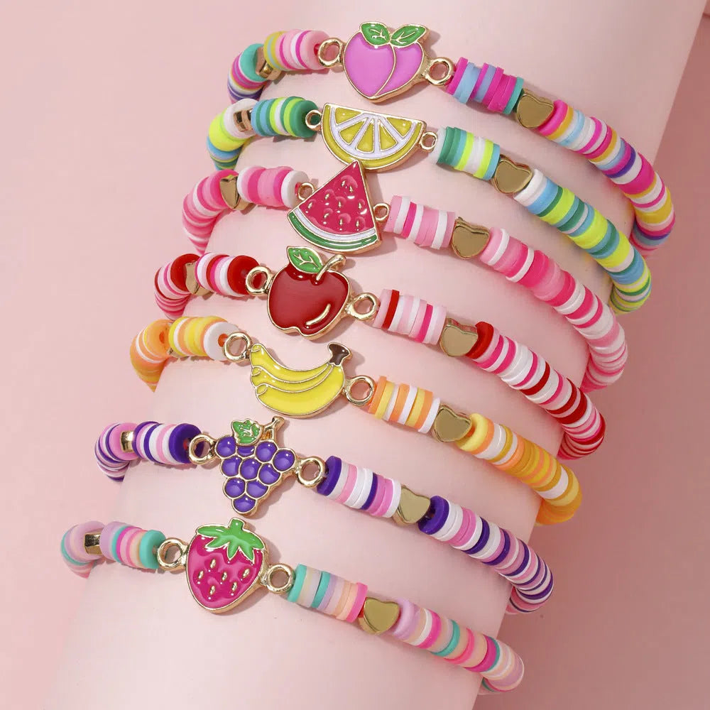 Children's polymer clay bracelet with dinosaur bead theme on a white background