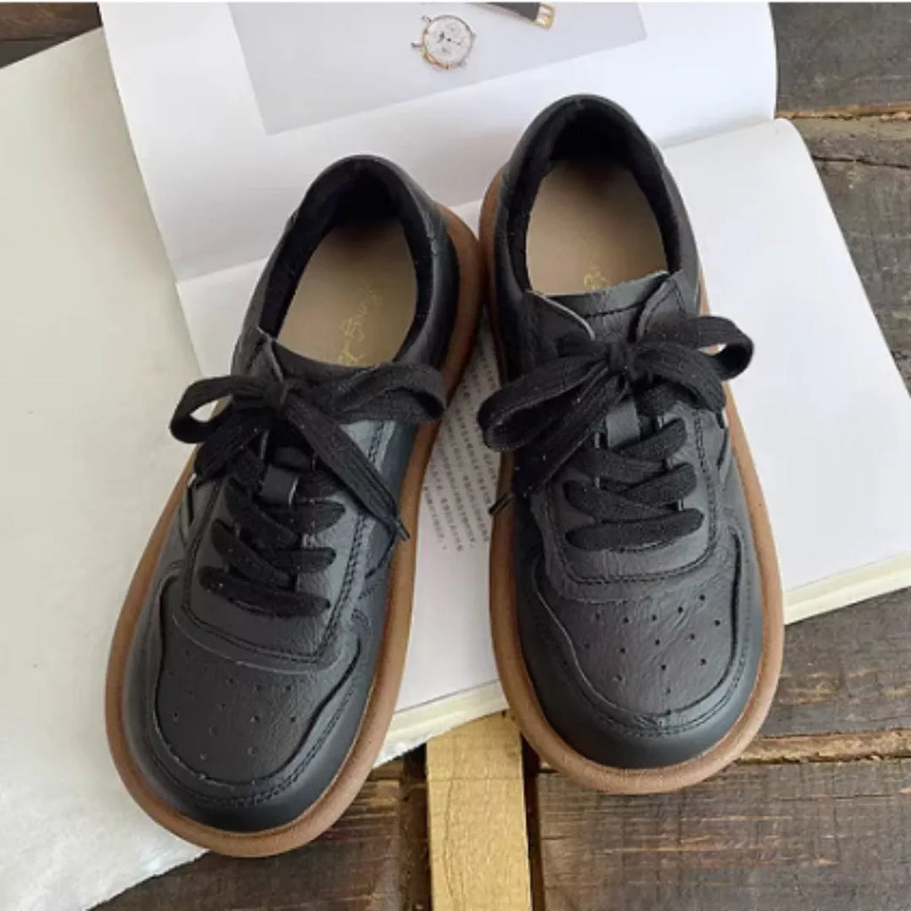 Round-toe cowhide leather lace-up flat shoes in black, soft rubber sole
