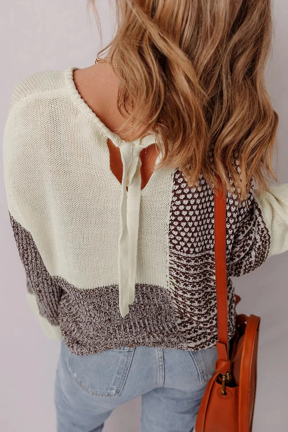 Dark khaki loose sweater with drop shoulders and a back tie fastening.