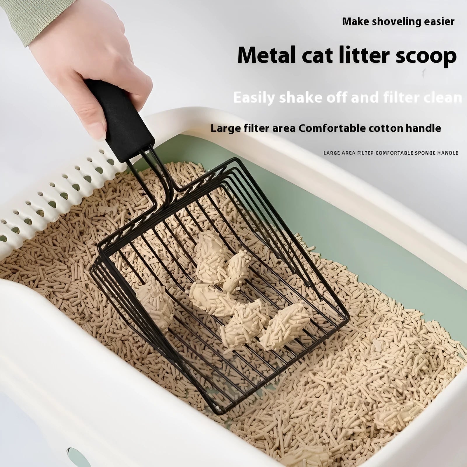 Black alloy metal cat litter scoop with narrow tines and a long handle.
