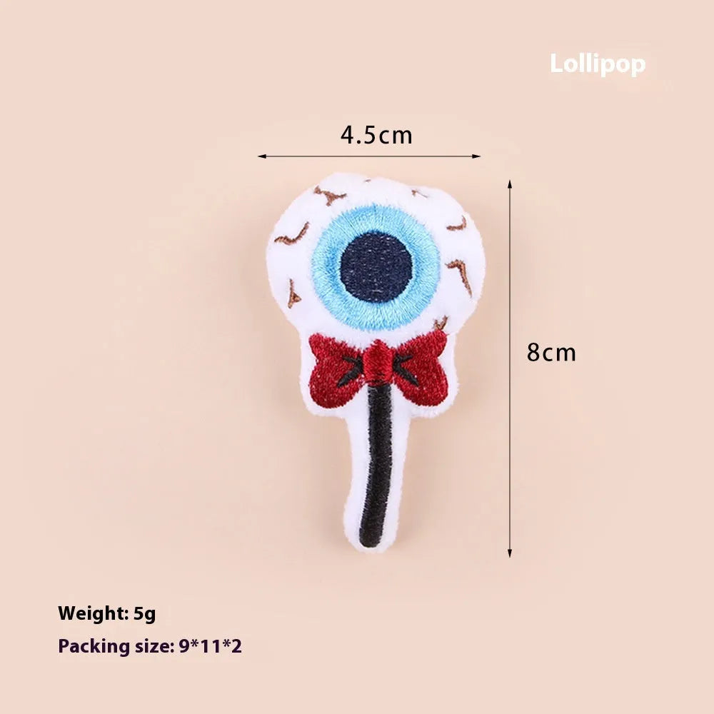 Plush cat teaser toy with three interchangeable heads: eyes, candy, and skull designs