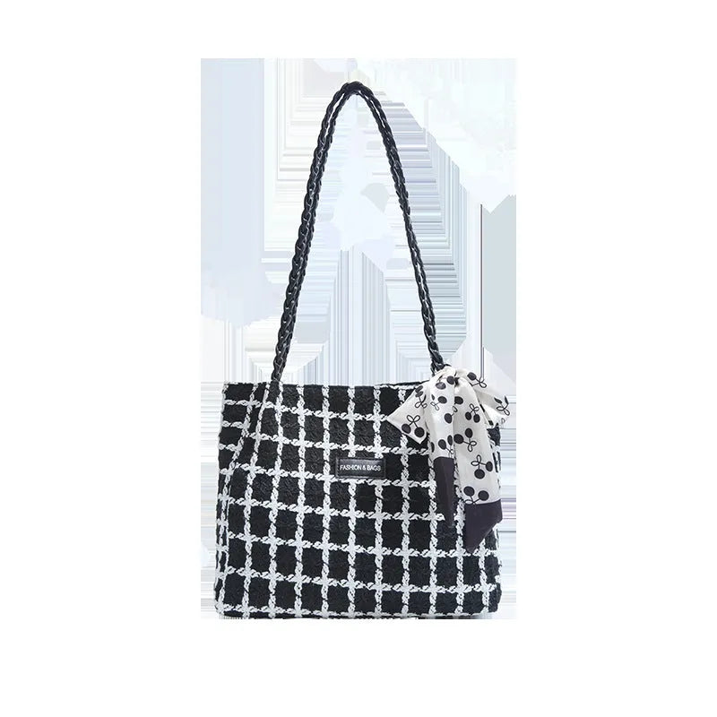 Black woven wool shoulder bag with horizontal square design showing internal organisation pockets and exterior sandwich compartment