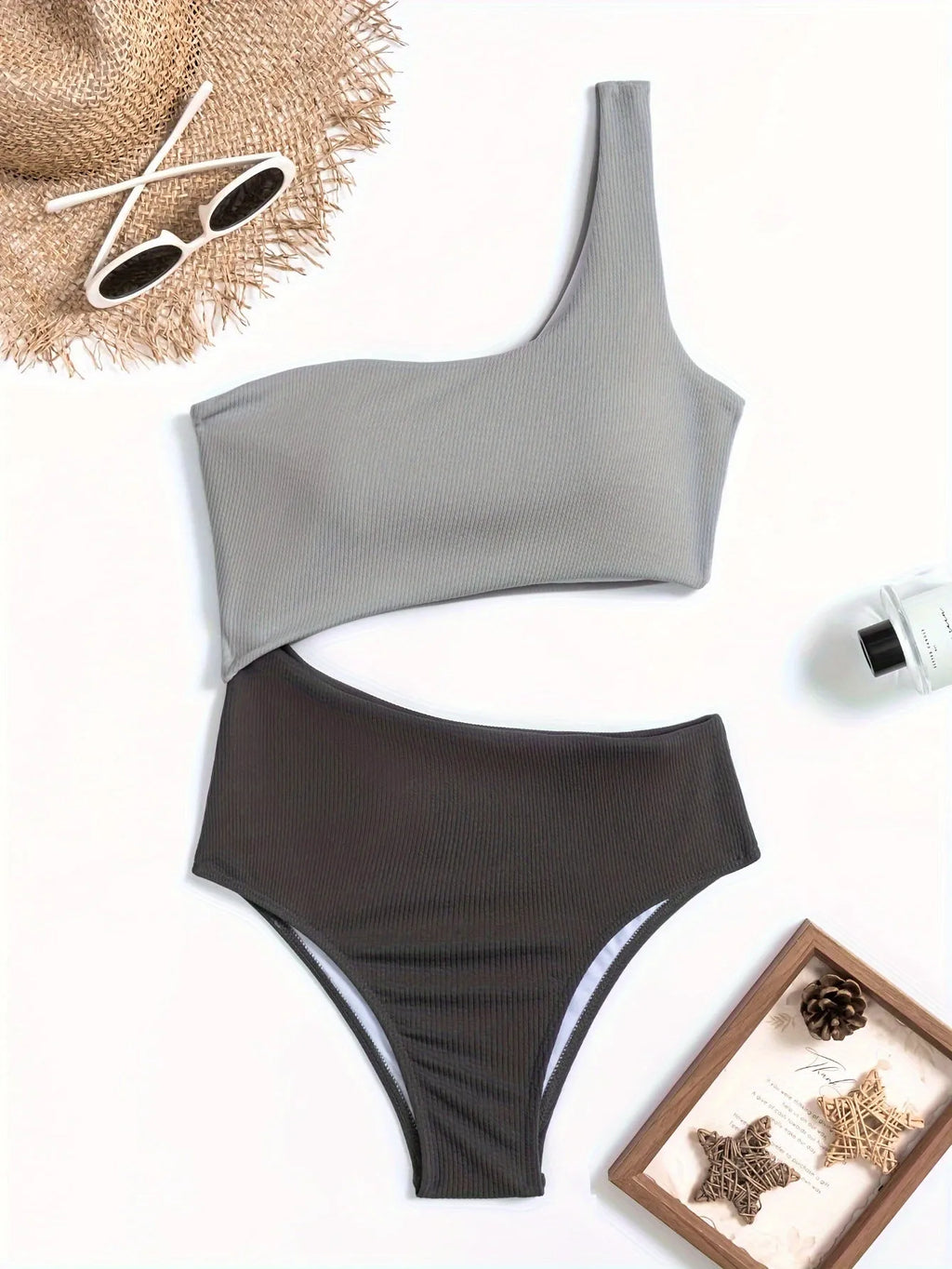 Light grey one-shoulder one-piece swimsuit on a mannequin, solid colour polyester fabric.