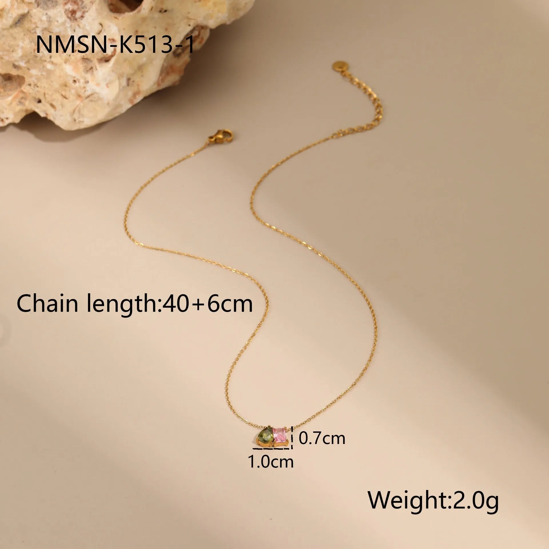 Geometric gold-plated jewellery set with necklace, earrings, and ring on display