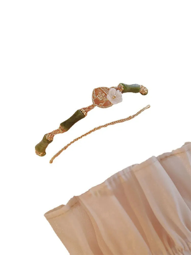 Natural olivine gemstone bracelet for women with double layer design and twin bells of Ireland charms.