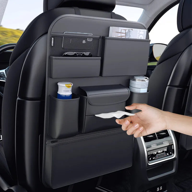 Black leather car seat back hanging storage organiser bag with handle shown mounted on a headrest.
