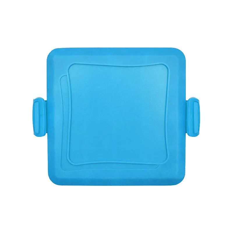Red silicone baking tray and oven gloves set on a kitchen counter.