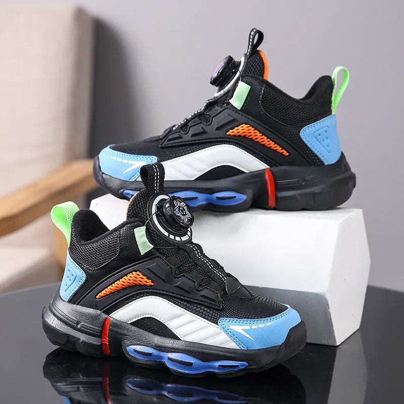 Children's waterproof leather basketball shoes with rotating buckle, black and grey colour, on natural lawn