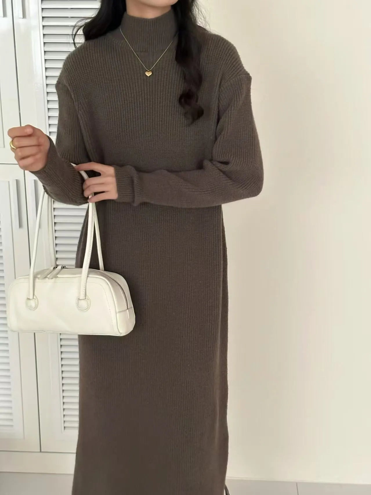 Women's knitted half turtleneck dress in acrylic with long sleeves and a high-waisted midi skirt.