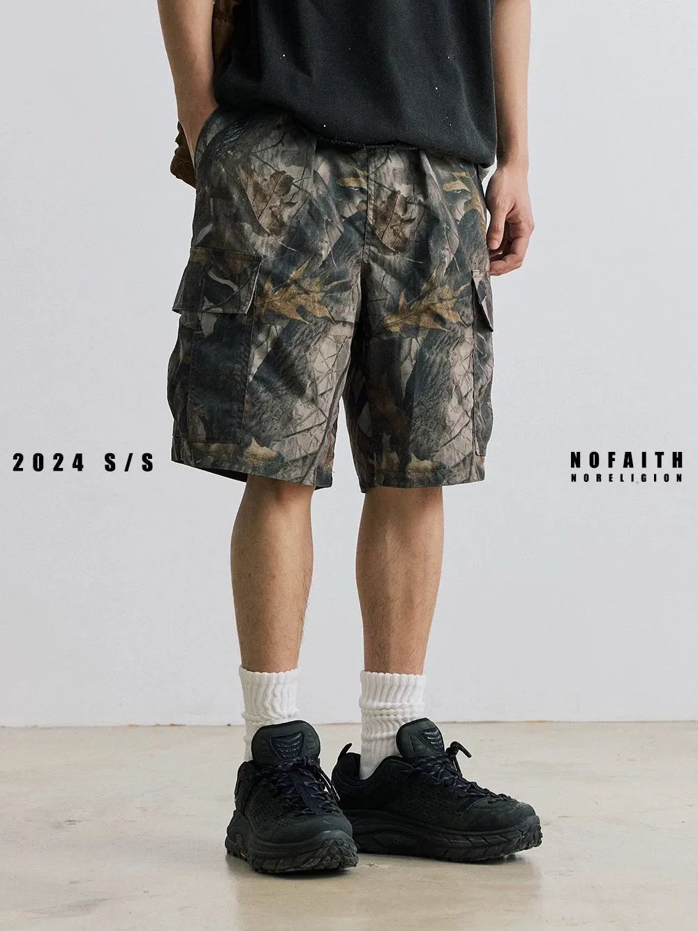 Straight-leg denim shorts in black and army green colours showing loose casual fit and mid waist design