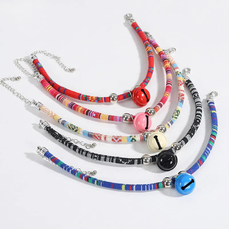 Adjustable pet collar with bell in ethnic pattern, showing colour options: black, blue, pink, red, white.