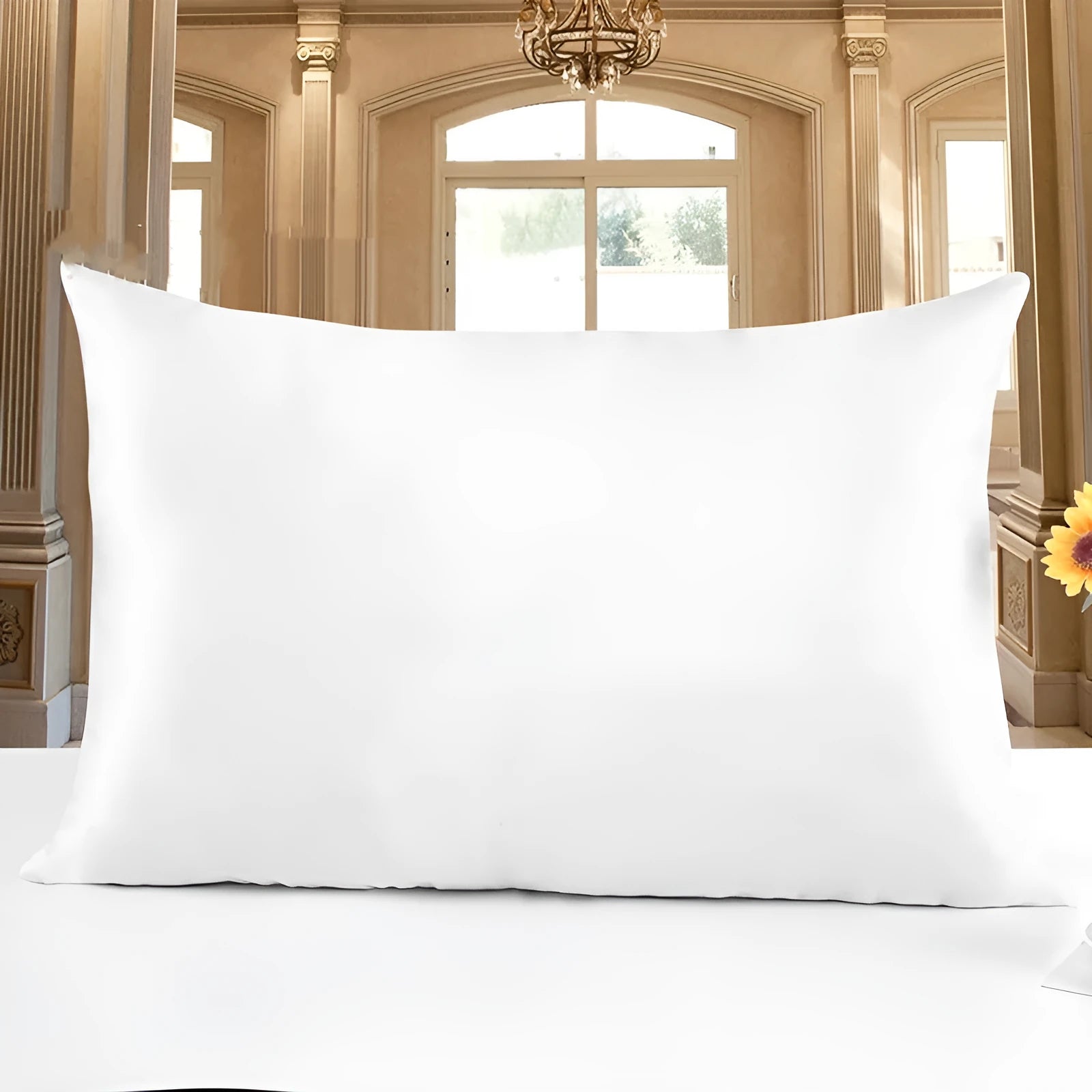 19 M double-sided silk pillowcase in apricot colour on a bed.