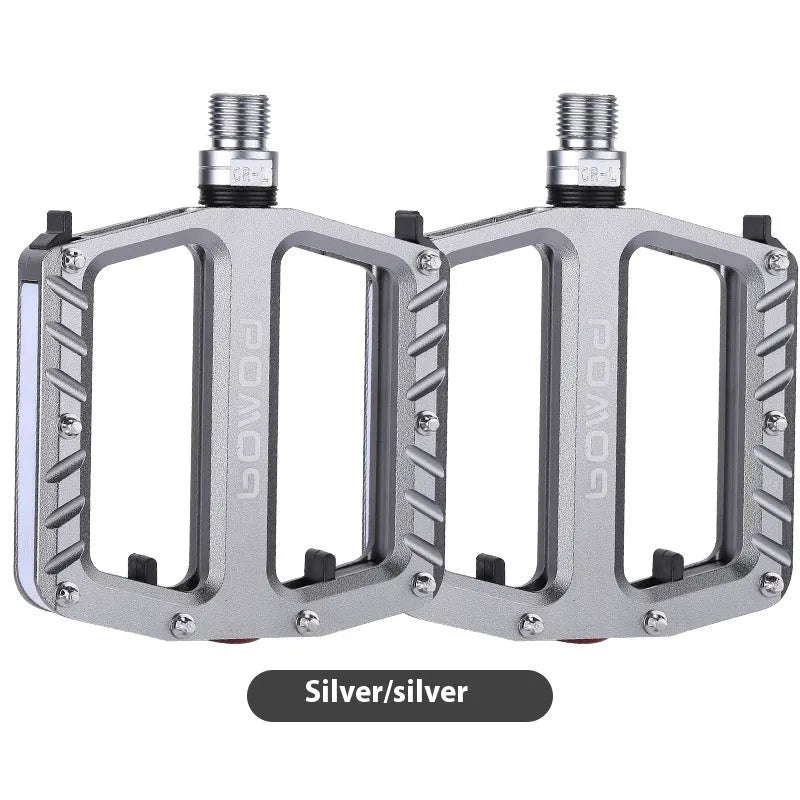 Bicycle pedals with LED lights in purple, black, titanium, red, and gold colour options