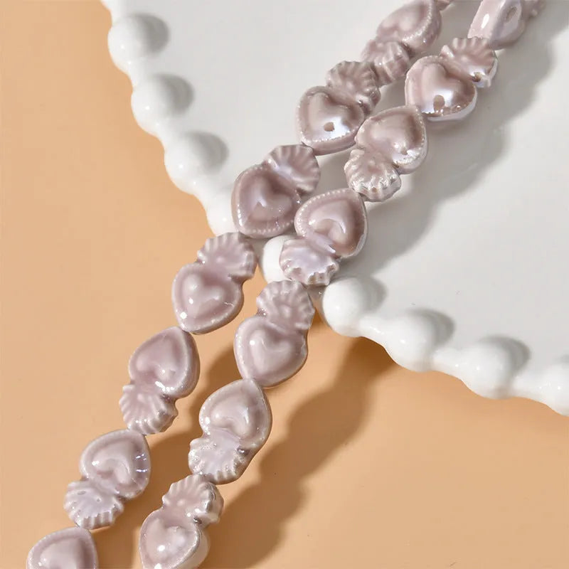 Ceramic heart torch beads in various colours for jewellery making, approximately 10mm by 15mm with straight hole