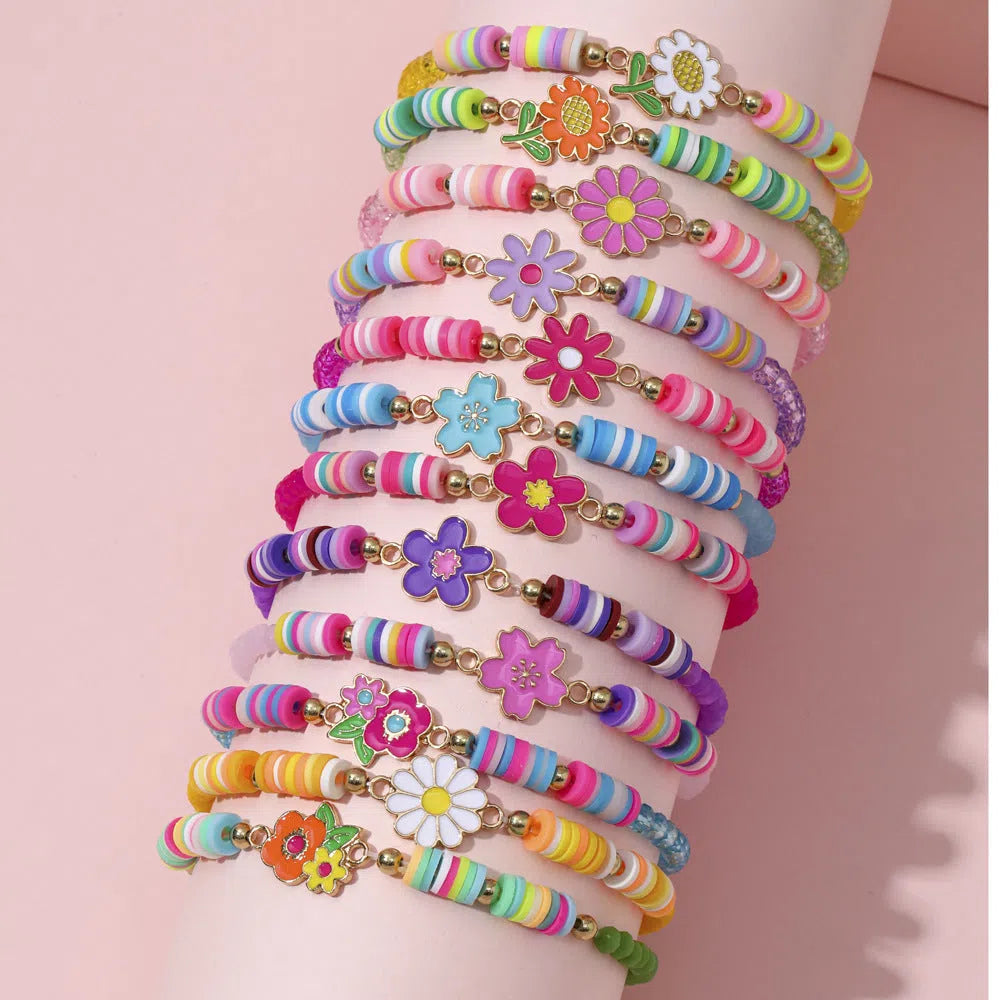 Children's polymer clay bracelet with dinosaur bead theme on a white background