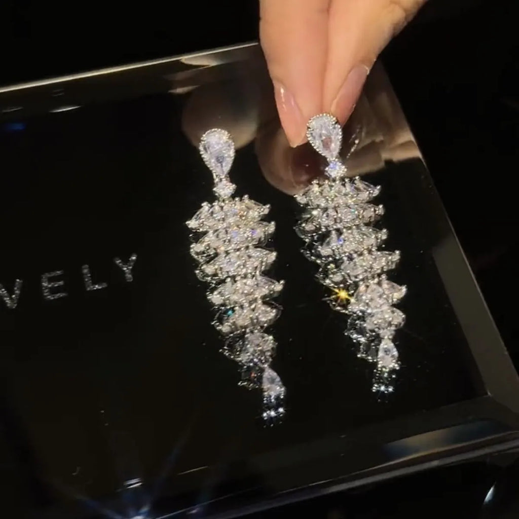 Silver pagoda coloured copper Christmas tree drop earrings with sparkling zircon details and stud fastening.